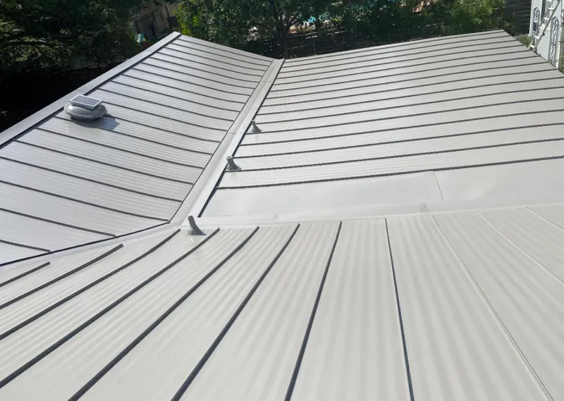 Solar attic fan installed on a metal roof for Roof Ventilation in Lonsdale
